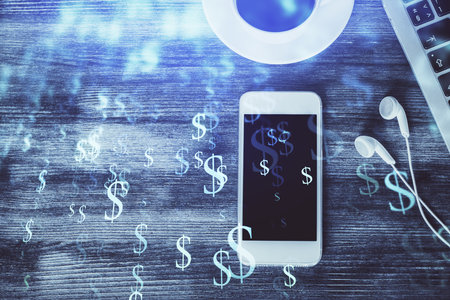 Double exposure of forex chart hologram over desktop with phone. Top view. Mobile trade platform concept.の写真素材