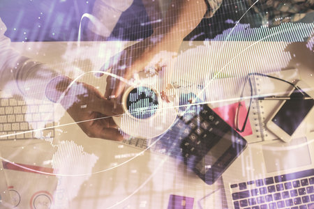 Double exposure of man and woman working together and financial chart hologram drawing. market analysis concept. Computer background. Top View.の写真素材