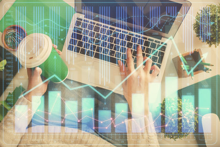 Double exposure of woman hands working on computer and forex chart hologram drawing. Top View. Financial analysis concept.の写真素材