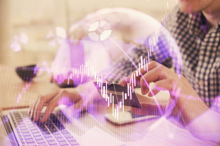 Double exposure of man hands holding a credit card and Forex graph drawing. Stock trading and...