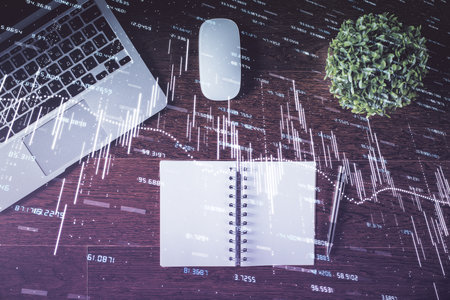Stock market graph and top view computer on the table background. Double exposure. Concept of financial education.の写真素材