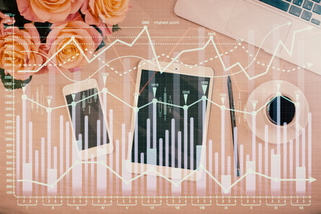 Double exposure of forex graph hologram over desktop with phone. Top view. Mobile trade platform concept.の写真素材