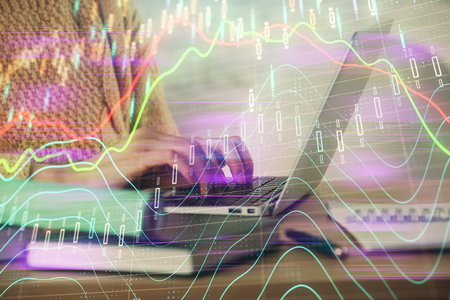 Double exposure of woman hands typing on computer and forex chart hologram drawing. Stock market...