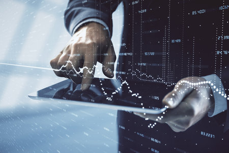 Double exposure of mans hands holding and using a digital device and forex graph drawing. Financial market concept.の写真素材