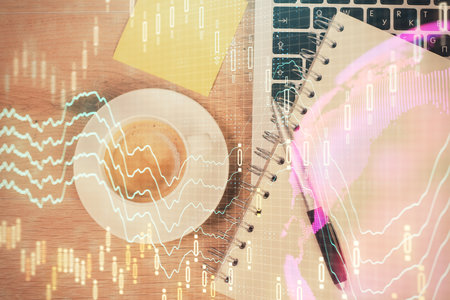 Double exposure of financial chart drawing over table background with computer. Concept of research and analysis. Top view.の写真素材