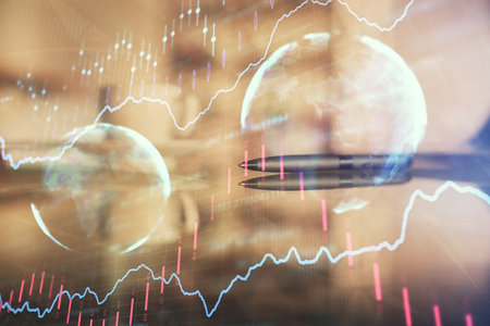 Double exposure of forex chart over coffee cup background in office. Concept of financial analysis and success.の写真素材