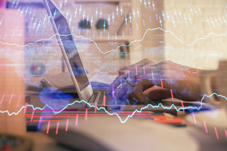Double exposure of woman hands typing on computer and forex chart hologram drawing. Stock market...