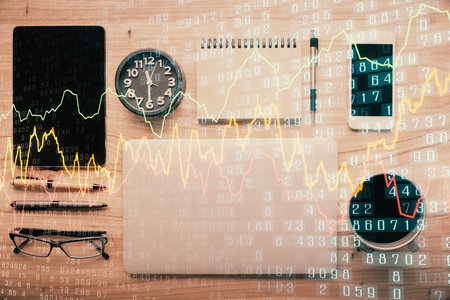 Double exposure of forex graph hologram over desktop with phone. Top view. Mobile trade platform concept.の写真素材