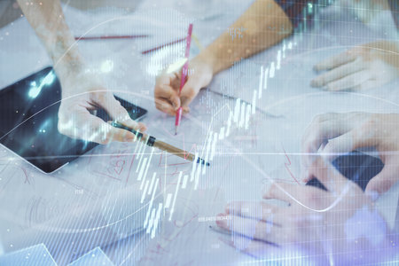 Double exposure of forex graph drawing and man and woman working together holding and using a mobile...