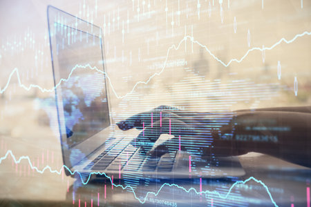 Double exposure of woman hands typing on computer and forex chart hologram drawing. Stock market...