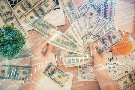 Multi exposure of financial graph drawing hologram and USA dollars bills and man hands. Analysis concept.の写真素材
