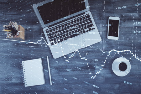 Double exposure of forex chart drawing over table background with computer. Concept of financial research and analysis. Top view.の写真素材