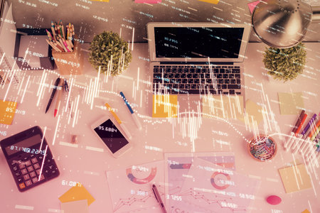 Double exposure of forex chart drawing over table background with computer. Concept of financial research and analysis. Top view.の写真素材