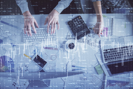Double exposure of man and woman working together and financial chart hologram drawing. market analysis concept. Computer background. Top View.の写真素材