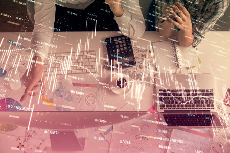 Double exposure of man and woman working together and financial chart hologram drawing. market...
