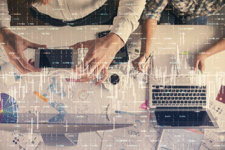 Double exposure of man and woman working together and financial chart hologram drawing. market analysis concept. Computer background. Top View.の写真素材