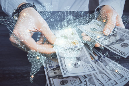 Multi exposure of financial theme drawing hologram and USA dollars bills and man hands. Business concept.の写真素材