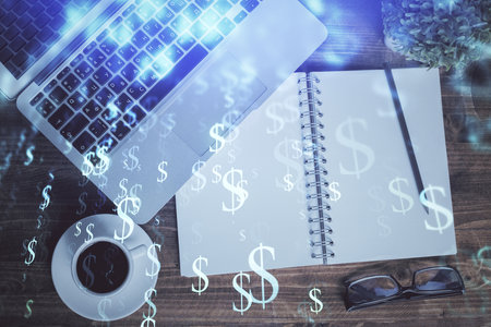 Financial market graph and top view computer on the desktop background. Double exposure. Investment concept.の写真素材