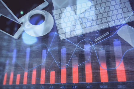 Double exposure of forex chart hologram over desktop with phone. Top view. Mobile trade platform concept.の写真素材
