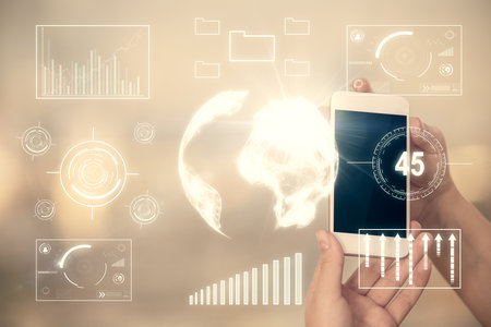Double exposure of forex graph sketch hologram and woman holding and using a mobile device. Stock...