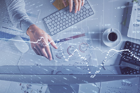 Multi exposure of mans hands typing over computer keyboard and forex graph hologram drawing. Top view. Financial markets concept.の写真素材