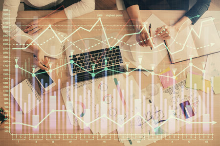 Double exposure of woman hands working on computer and forex graph hologram drawing. Top View. Financial analysis concept.の写真素材