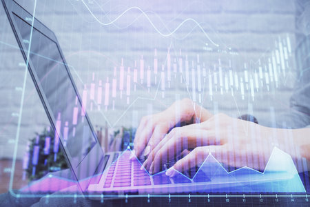 Multi exposure of woman hands typing on computer and forex chart hologram drawing. Stock market analysis concept.の写真素材