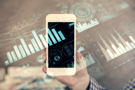 Double exposure of mans hands holding and using a digital device and forex graph drawing. Financial market concept.の写真素材