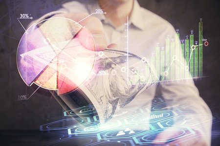 Multi exposure of financial graph drawing hologram and USA dollars bills and man hands. Analysis concept.の写真素材