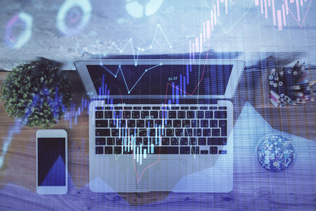 Multi exposure of financial chart drawing over table background with computer. Concept of research and analysis. Top view.の写真素材