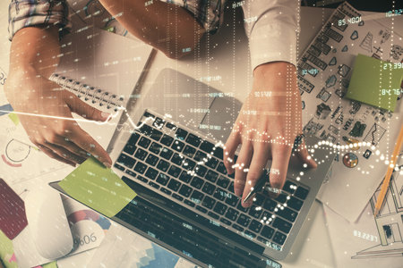 Double exposure of man and woman working together and forex graph hologram drawing. Financial...