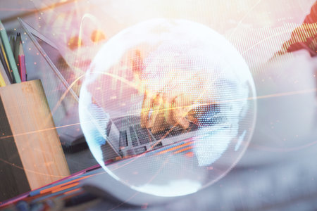 Double exposure of woman hands typing on computer and business theme hologram drawing. Success concept.の写真素材