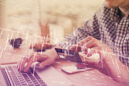 Double exposure of man hands holding a credit card and Forex graph drawing. Stock trading and...