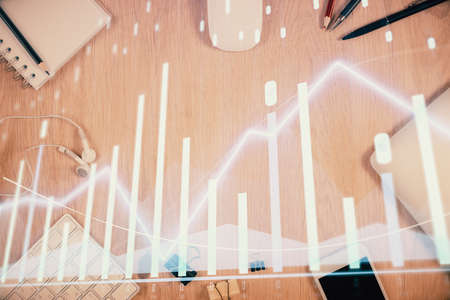 Multi exposure of forex graph hologram over desktop with phone. Top view. Mobile trade platform concept.の写真素材