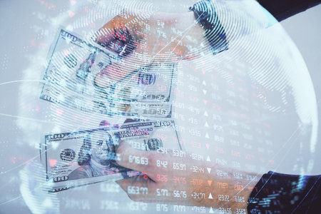 Multi exposure of financial theme drawing hologram and USA dollars bills and man hands. Business concept.の写真素材