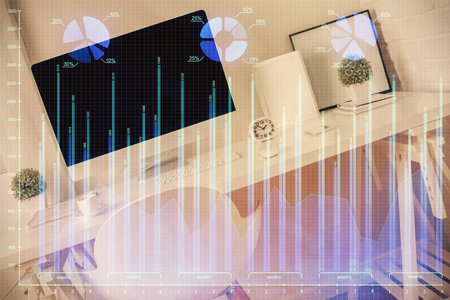Double exposure of financial graph drawing and office interior background. Concept of stock market.の写真素材