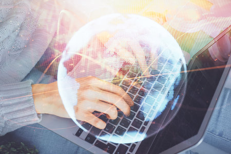 Double exposure of woman hands typing on computer and business theme hologram drawing. Success concept.の写真素材