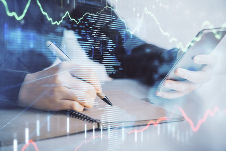 Double exposure of forex graph sketch hologram and woman holding and using a mobile device. Stock market concept.の写真素材