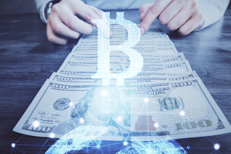 Multi exposure of blockchain theme drawing hologram and USA dollars bills and man hands. Business concept.の写真素材