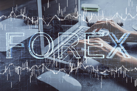 Double exposure of woman hands typing on computer and forex chart hologram drawing. Stock market invest concept.の写真素材