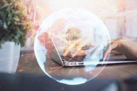 Double exposure of woman hands typing on computer and business theme hologram drawing. Success concept.の写真素材