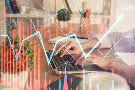 Double exposure of woman hands typing on computer and forex chart hologram drawing. Stock market...