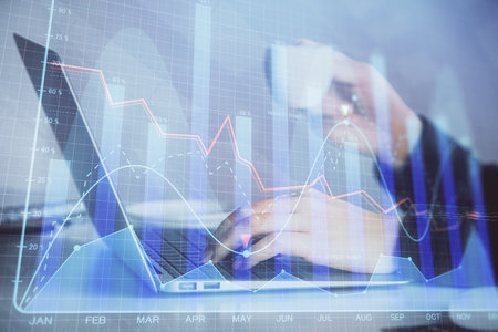 Double exposure of businesswoman hands typing on computer and forex graph hologram drawing. Financial analysis concept.の写真素材
