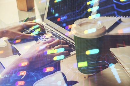 Double exposure of woman hands working on computer and data theme hologram drawing. Tech concept.の写真素材