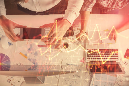 Double exposure of man and woman working together and financial chart hologram drawing. market...