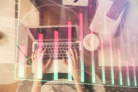 Double exposure of woman hands working on computer and forex chart hologram drawing. Top View. Financial analysis concept.の写真素材