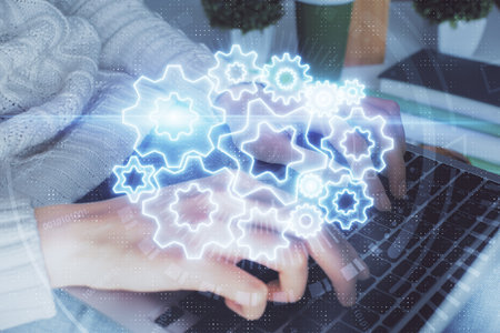 Double exposure of woman hands typing on computer and business theme hologram drawing. Success...