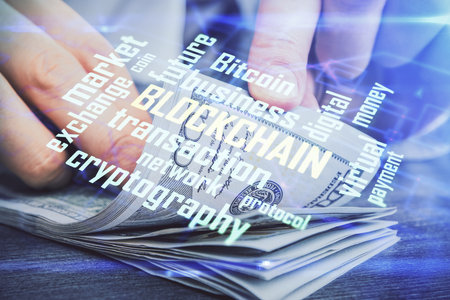 Multi exposure of blockchain theme drawing hologram and USA dollars bills and man hands. Business concept.の写真素材