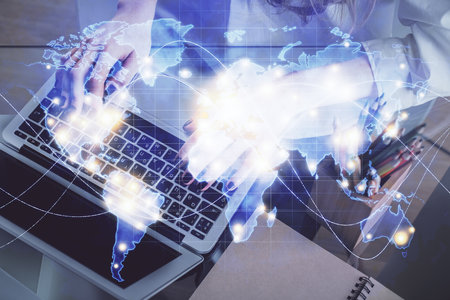 Double exposure of woman hands typing on computer and business theme hologram drawing. Success...