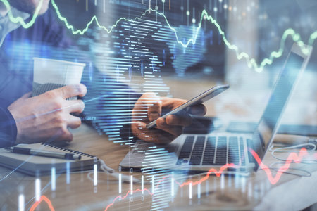 Double exposure of mans hands holding and using a phone and financial graph drawing. Analysis...